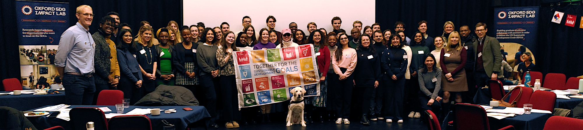 Large diverse crowd of people with an SDGs banner