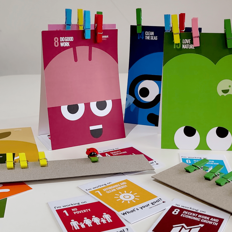 Brightly coloured games cards and playing pieces for the UN SDGs (Sustainable Development Goals)